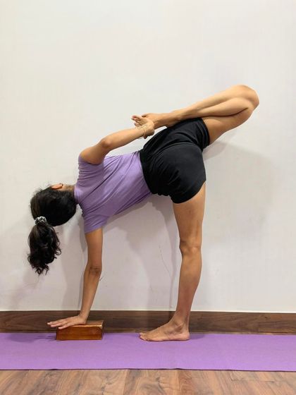 This is Ardha Chandrasana (Half Moon Pose) with the back leg in Padmasana (Lotus Pose). This advanced variation challenges balance and combines a standing pose with a deep hip opener.