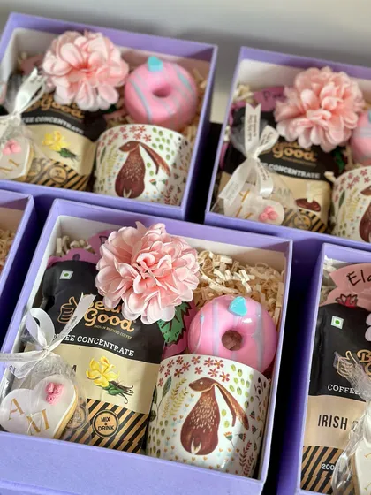 A close-up of my baby shower and first birthday return favors. This option includes a cute rabbit-themed mug, coffee concentrate, a custom cookie, and a donut soap.