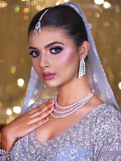 Another angle of this glamorous and modern bridal look. The cool-toned makeup and sparkling jewelry create an ethereal and enchanting vibe.