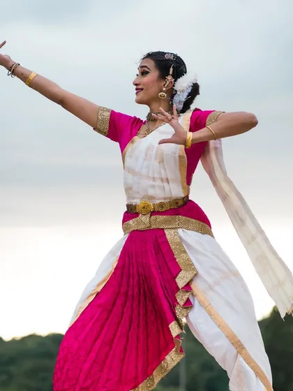 An outdoor photoshoot in Paris in my full Bharatanatyam costume. The dynamic pose against the open sky creates a beautiful contrast between the ancient art form and the European landscape.