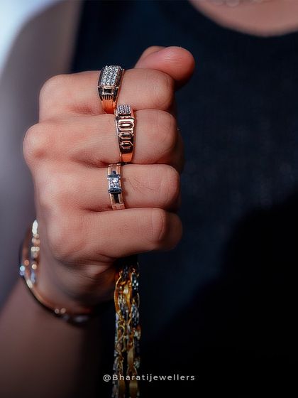 A handful of style. This image displays our modern men's rings and a classic gold chain, reflecting unique style and grace.