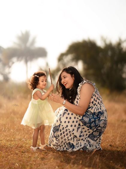 A mother and daughter sharing a playful moment in a field. I encourage natural interaction to capture photos that truly reflect your family's bond.