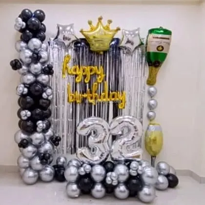 A duplicate of the 32nd birthday home decoration, showing the full arrangement of balloon columns and foil balloons.