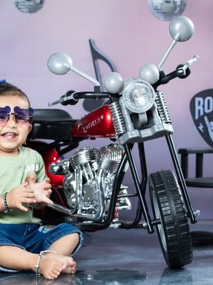 This little rockstar is having a blast with his star-shaped sunglasses. The playful energy in this shot is infectious.