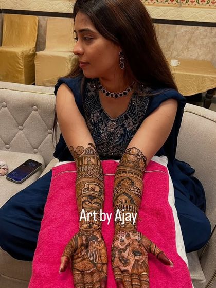 The final result. A happy bride with her stunning, intricate portrait mehndi, ready for her big day.