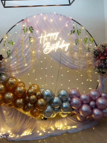 The birthday backdrop seen from the side, showing the depth created by the flowers and drapes.