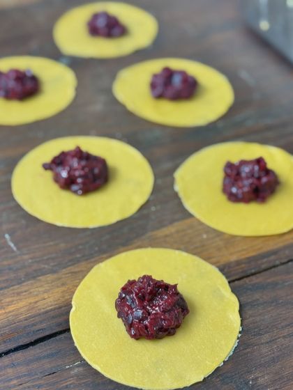 Fresh pasta circles being filled with a rich beetroot mixture for our tortellini.