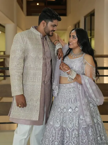A stylish portrait of the couple, showing off their coordinated pastel engagement outfits.