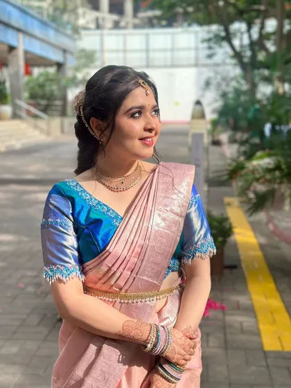 A beautiful outdoor shot of Payal. The natural light highlights the dewy finish of her skin and the soft colors of her makeup.