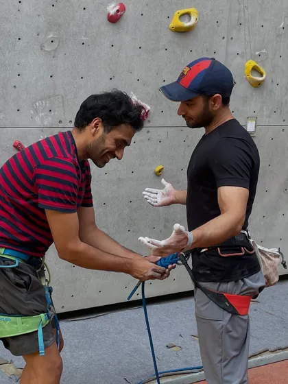 A final check before starting a lead climb. Our climbers and staff prioritize safety, ensuring every knot is tied and every piece of gear is double-checked.
