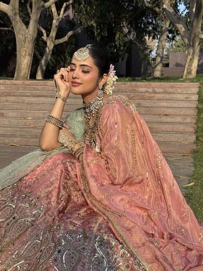 A dreamy, romantic shot of the bride basking in the sun. The soft colors of the lehenga are perfect for a daytime wedding.