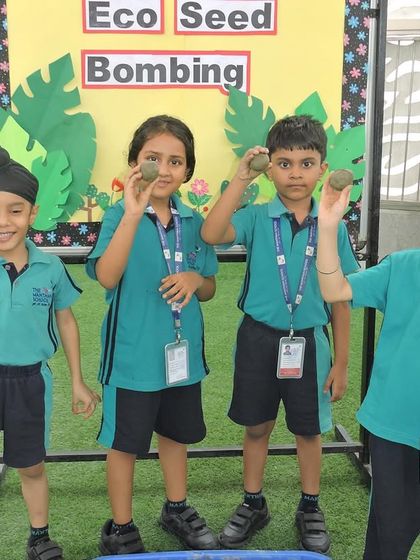 Four students showcase the seed bombs they created, ready to contribute to a greener environment.