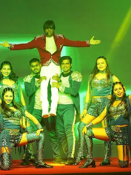 The iconic 'lift' pose with the full team. This is a signature photo opportunity that clients love.