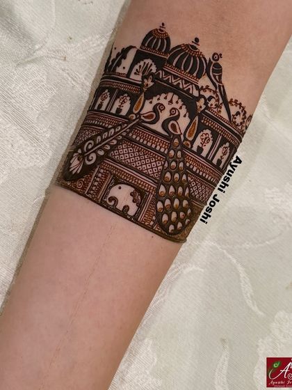 A detailed shot of the armband, featuring a royal palace scene with peacocks and elephants, demonstrating the intricacy of my work.