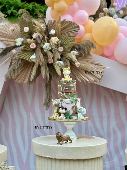 A close-up of the themed birthday cake, adorned with adorable fondant safari animals.