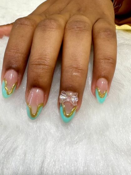 A full view of the hand with the turquoise and gold design, showcasing the beautiful 3D bow.