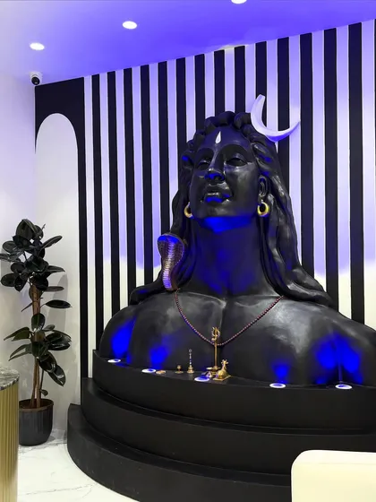 The completed Shiv installation, perfectly integrated with the office lobby's modern decor, including planters and the reception desk.