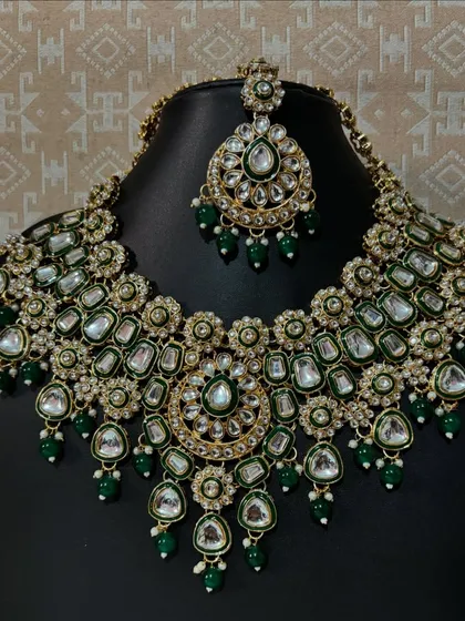 This green Kundan bridal necklace set is a statement piece for any bride. The combination of large Kundan stones and delicate green beads gives it a royal look, perfect for pairing with a traditional lehenga or saree.