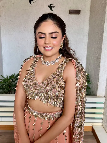 A close-up of the soft peach glam, with eyes closed to showcase the shimmery eyeshadow. This look is perfect for a cocktail party or reception.