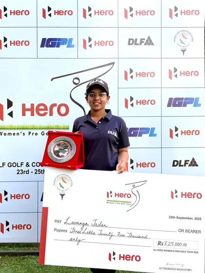 A solo shot of Lavanya Jadon celebrating her first professional win at the Hero WPGT, holding her prize check and trophy. A milestone moment in her journey from a junior to a professional golfer.
