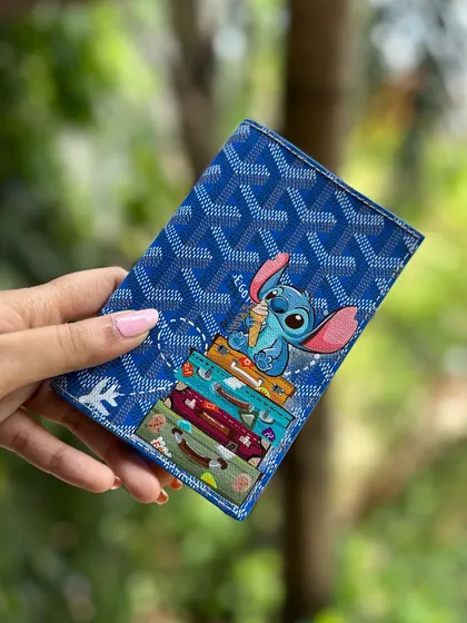 Holding up the finished Stitch passport cover. It's ready for some adventures!