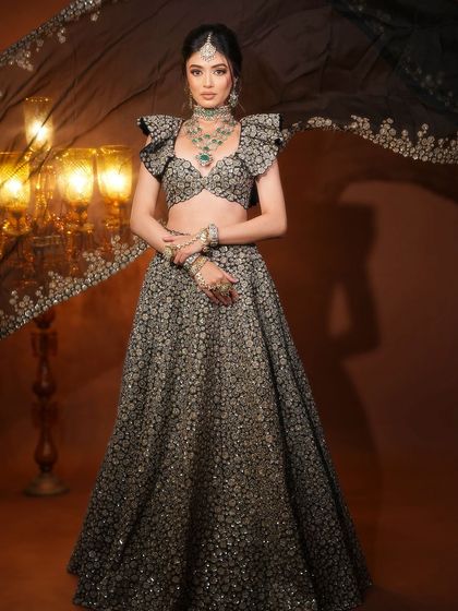 The full look, with a dramatic flowing dupatta. The makeup is elegant and timeless, perfect for a modern maharani.