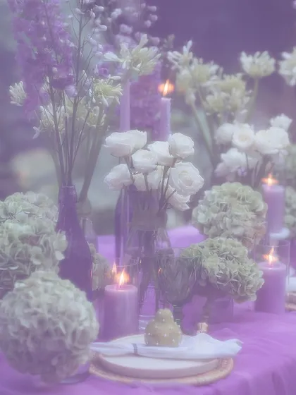 A dreamy, soft-focus shot of the candlelit floral arrangement, creating a magical and romantic mood.