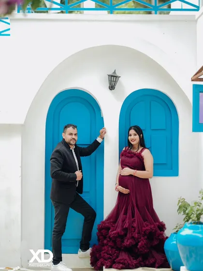 A classic couple's pose against the Santorini-style blue doors, perfect for a modern and vibrant shoot.