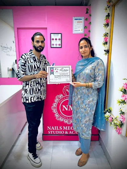 Seeing my students succeed is the best part of my job. Here I am with a student who has just completed her professional nail course and is holding her hard-earned certificate.