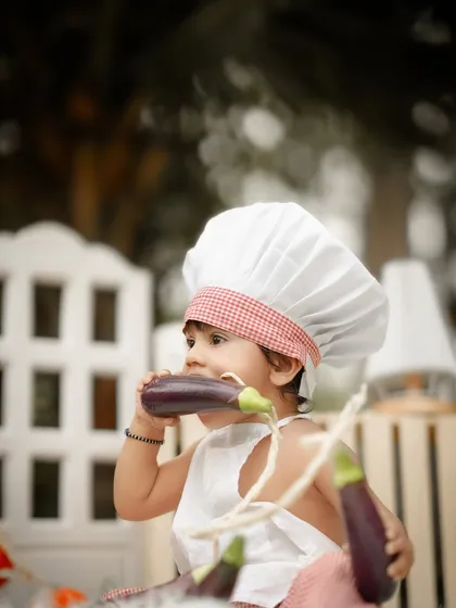 This little chef seems to be taste-testing the vegetables. I love the funny and unpredictable moments that happen during these creative shoots.