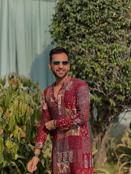 Baraat-ready in Daman. This printed red kurta is perfect for a vibrant and energetic wedding procession by the sea.