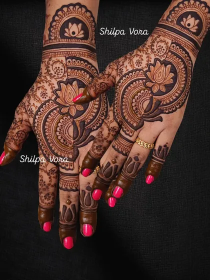 A bold and beautiful design with a large, stylized lotus taking center stage on the back of the hands.