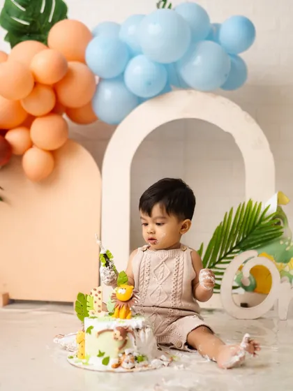 This little one is carefully inspecting his jungle-themed birthday cake before the big smash. The anticipation is just as cute as the event itself.