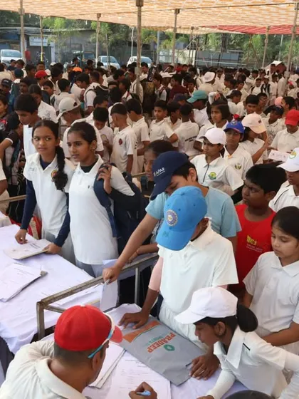 A view of the crowded registration area, showing boys and girls ready to showcase their skills.