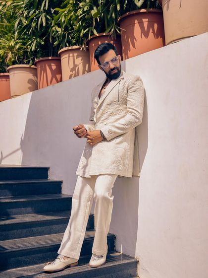 In a world full of color, dare to wear white. This textured white Indo-Western suit from the Sukoon collection brings timeless charm and radiance to your day wedding style.