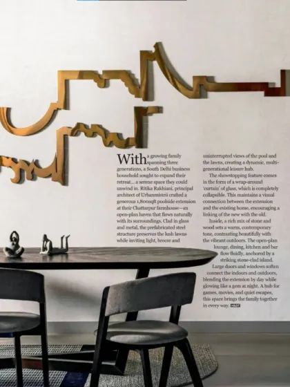 In the dining area, a custom metal art piece adorns the wall, adding a sculptural element that complements the clean lines of the furniture. The open plan ensures a constant connection to the living area and the views beyond.