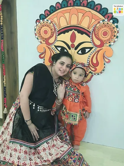 A mother and her son pose in front of our beautiful, festive backdrop during the Navratri event. We make sure our space feels special for every celebration.