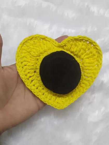 The heart scrunchie in a sunny yellow color. It's a fun and unique way to style your hair.