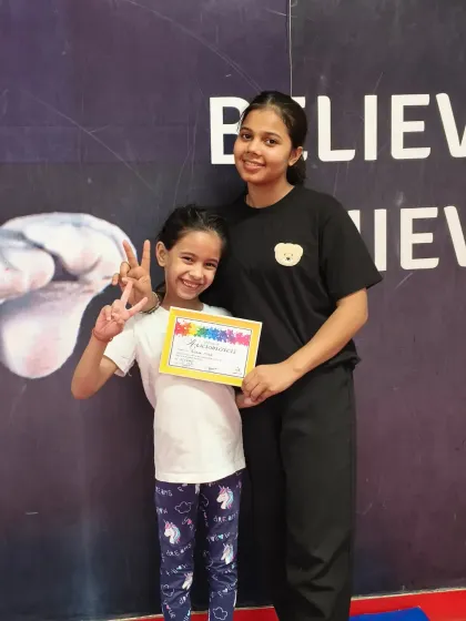 All smiles for this gymnast who just received her certificate. We love celebrating these moments of success.