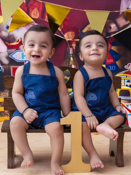 Double the fun! A carnival-themed first birthday shoot for twin boys. Their matching outfits and big smiles are absolutely infectious.