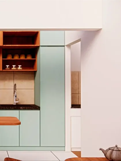 A view from the dining area into the kitchen. A tall pantry unit provides ample storage, a smart solution for a kitchen where space is at a premium.