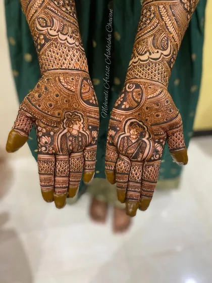 A bridal mehendi with portraits of the bride and groom. The intricate details and personalized touch make this design truly special.