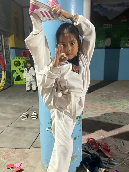 One of my youngest students showing her version of the one-leg kick hold. The new generation is ready and updated.