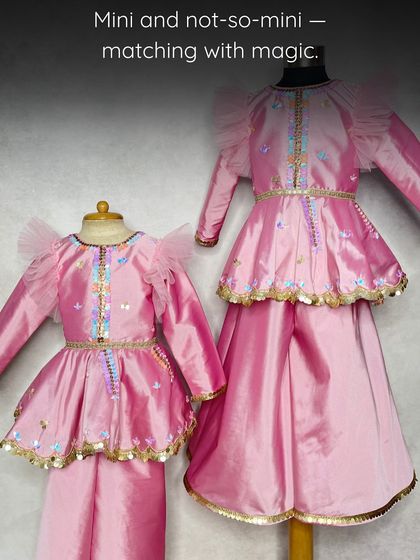 Mini and not-so-mini, matching with magic. This shows the size difference in the pink peplum sets, perfect for sisters with an age gap.