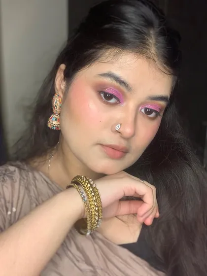A complete look showing the pink eye makeup paired with traditional bangles.