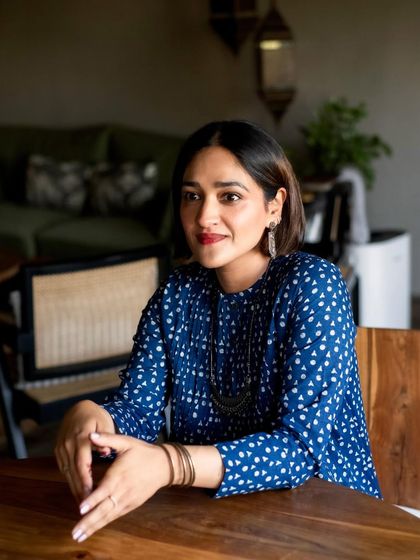 A portrait of an author in her home, relaxed and smiling. My goal is to make you feel comfortable enough to let your true self shine.