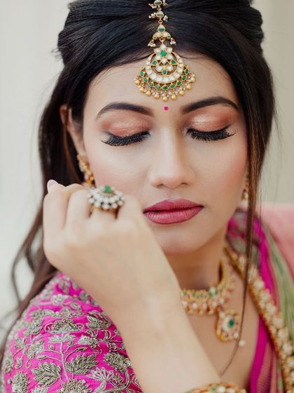 A close-up on the eye makeup, featuring soft brown and pink tones with dramatic lashes to make the eyes stand out.