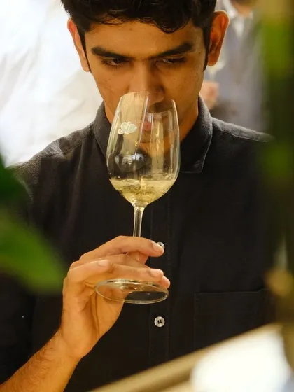A guest is captured enjoying a glass of wine at our Wine Carnival, an event that received significant press coverage for its scale and quality.