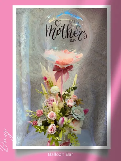Our "Floral Flair Floaters" are a beautiful way to spoil mom. This hamper features a custom "Happy Mother's Day" balloon floating above a delicate arrangement of pampas grass and pastel-colored flowers.