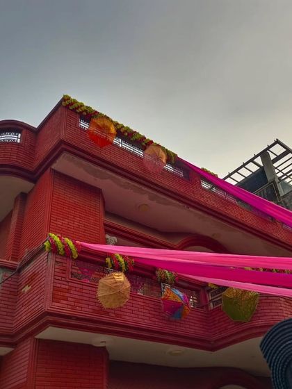 A low-angle view of the balcony decorations, showing the details of the hanging ornaments and drapes.